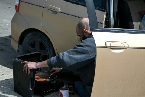 Some of those displaced have been forced to get by in the streets, cooking next to their cars