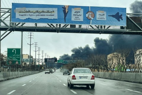 As Tehran residents returned to work on Sunday, black smoke from Israeli oil depot strikes rise into the air