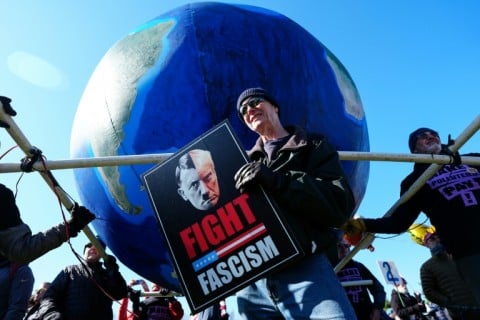An anti-fascism protester in Washington holds a sign that compares US President Donald Trump to Nazi leader Adolf Hitler