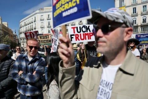 A US national day of protest against President Donald Trump has spilled over to several cities in Europe including Madrid, where demonstrators help provocative signs