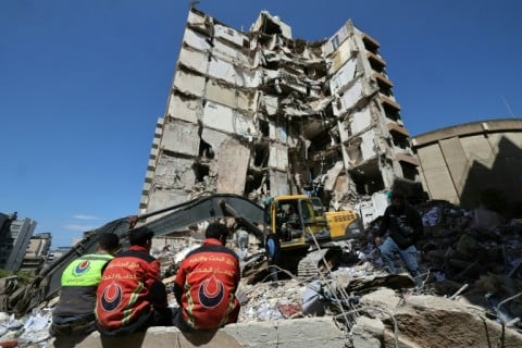 Lebanese rescuers clear the rubble at the site of an Israeli airstrike in Beirut