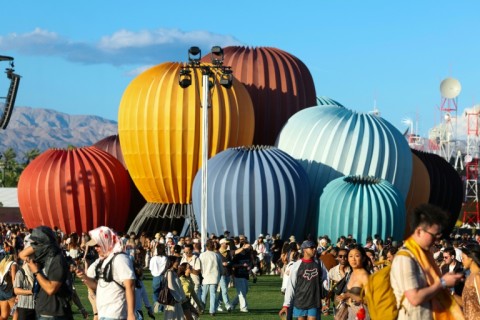 Festival-goers walk near the "Starry Eyes" installation, designed by architect Kyriakos Chatziparaskevas, during the 2026 Coachella Valley Music and Arts Festival