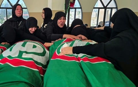 People mourn victims killed earlier this week by Israeli airstrikes in Abbasiyeh on April 10, 2026