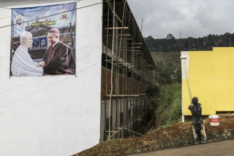A poster portraying Pope Leo XIV (L) and Archbishop of Bamenda Andrew Nkea (R) at the Saint Joseph Metropolitan Cathedral