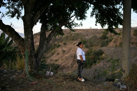 Tomasa Lopez surveys a deep ravine where she suspects a clandestine graveyard of gang victims may be located and which she theorizes could hold the remains of her daughter, who has been missing since 2016