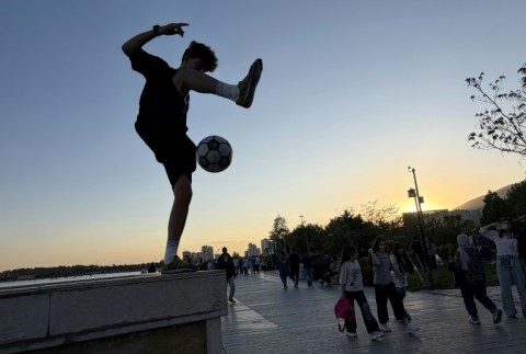 Tehranis coming out to enjoy the city's parks and cafes belies the mounting economic pressure that many are under