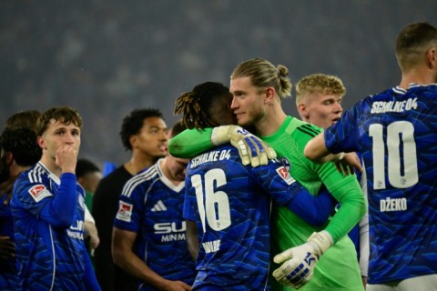 Schalke goalkeeper Loris Karius celebrates with the side after sealing promotion to the top flight.