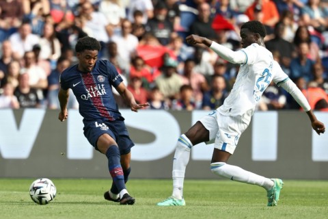 Ibrahim Mbaye (L) of Paris Saint-Germain and Abdoulaye Faye of Lorient fight for the ball.