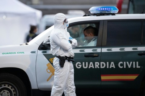 A Spanish civil guard wears a protective suit as the MV Hondius arrived at the industrial port of Granadilla de Abona on Tenerife on May 10, 2026