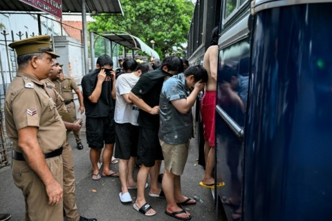 Prison guards escort detained Chinese nationals suspected of running cyberscams in Sri Lanka