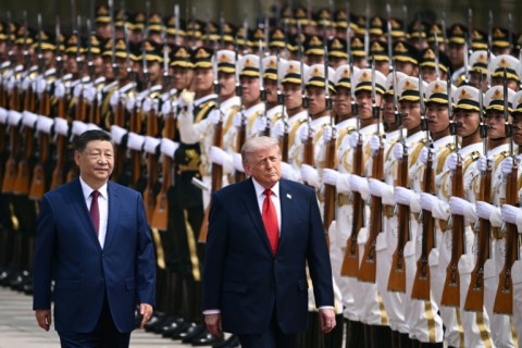 US President Donald Trump and China's President Xi Jinping inspect a guard of honour during a welcome ceremony at the Great Hall of the People in Beijing