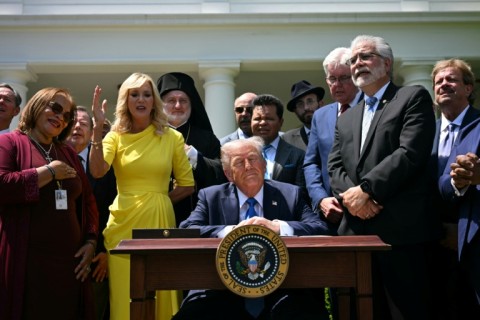 Trump spiritual advisor Paula White (2nd L) prays behind US President Donald Trump during a National Day of Prayer event at the White House in May 2025