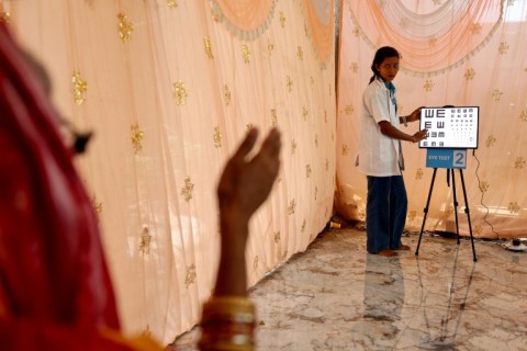 An optometrist conducts an examination at a screening camp in Cuttack's Maniabandha village
