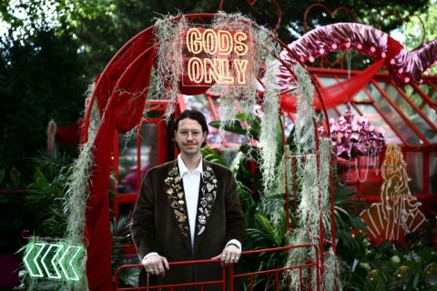 Designer James Whiting poses at his exhibit 'Aphrodite's Hothouse' billed as 'lush, fragrant and just a little bit naughty' at the 2026 RHS Chelsea Flower Show in London