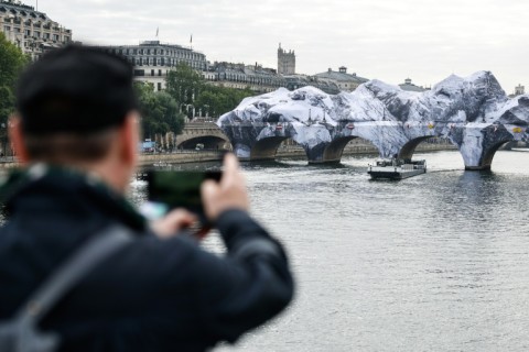 Tourists and Parisians alike were drawn to admire the creation by street artist JR