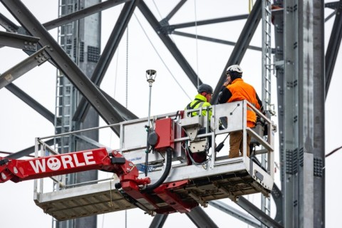 As workers braved a cold rain, the structure doubled in height within a matter of hours