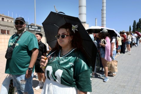 Fans queue outside the Estadi Olimpic Lluis Companys in Barcelona ahead of Bad Bunny's first concert in the Spanish city