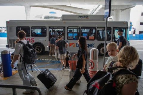 People board a shuttle at Los Angeles International Airport (LAX) in Los Angeles, California, on May 15, 2026