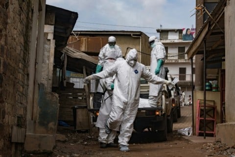 A Ugandan Red Cross worker during the evacuation of the body of a suspected Ebola victim in Kampala on May 26
