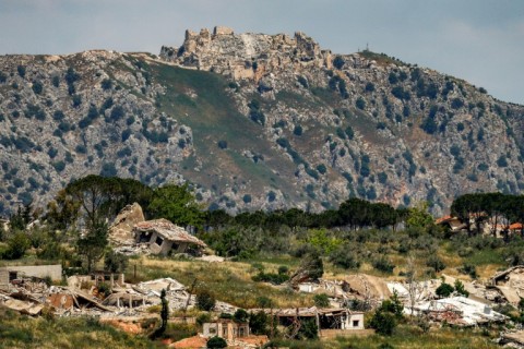 Destroyed buildings are pictured in the village of KfarKila in southern Lebanon as seen from across the border in the Upper Galilee region of northern Israel on May 29 with the Beaufort Castle pictured in Lebanon in the background