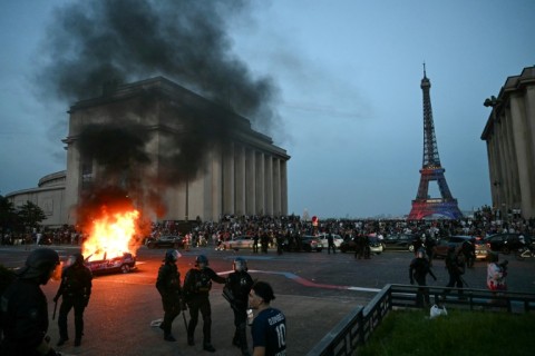 A car was set ablaze not far from the Eiffel Tower during the street celebrations