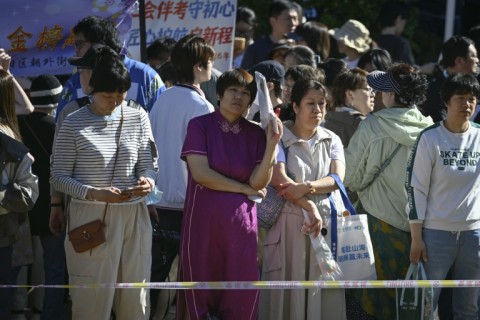 Anxious parents thronged the exam halls, hoping for the best for their children