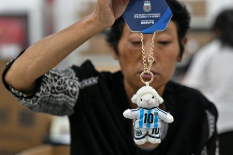 A worker packs merchandise of Lionel Messi in China