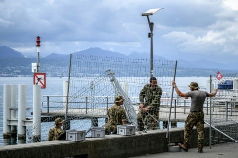 Swiss soldiers installing security fencing along the shore of Lake Geneva in Lausanne, ahead of the Evian G7 summit