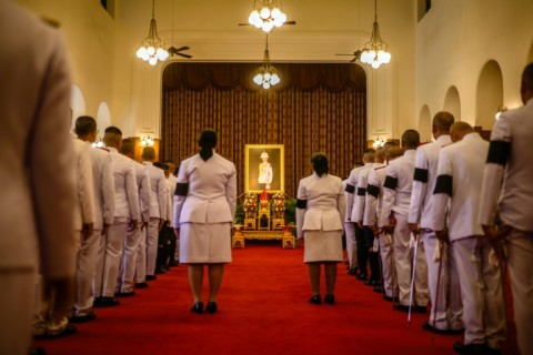 Officials line up to pay respects in front of a portrait of the late Thai Princess Bajrakitiyabha Mahidol in the royal throne hall at the Grand Palace in Bangkok on June 13, 2026.