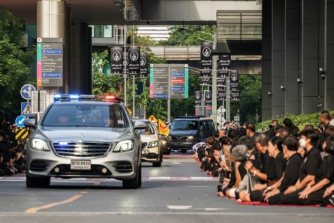 Mourners line the road outside Chulalongkorn Hospital to pay respects to Thai Princess Bajrakitiyabha Mahidol as her body is transported to the Grand Palace, where funeral rites will begin for the late princess, in Bangkok on June 13, 2026.