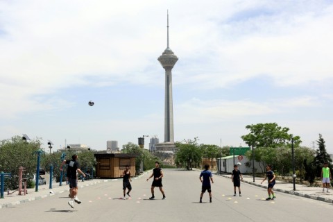Young people play football near Milad Tower in Tehran last month