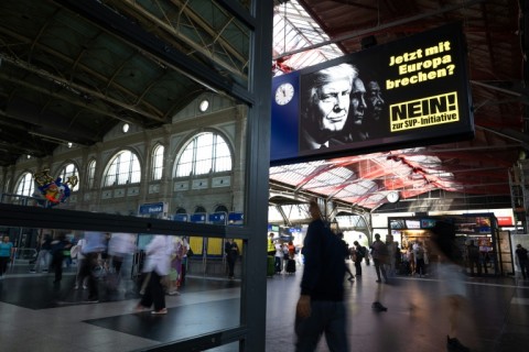 A campaign billboard at Zurich central station depicting US President Donald Trump and reading 'Isolating ourselves from Europe? Certainly not now!'