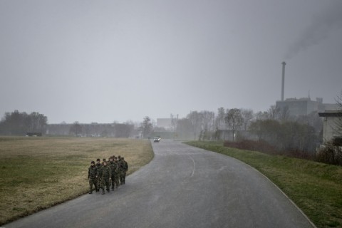Recruits marching along a road at a military training ground in Thun