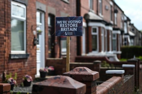 A sign for the Restore Britain party is pictured outside a row of houses, ahead of Thursday's Makerfield by-election