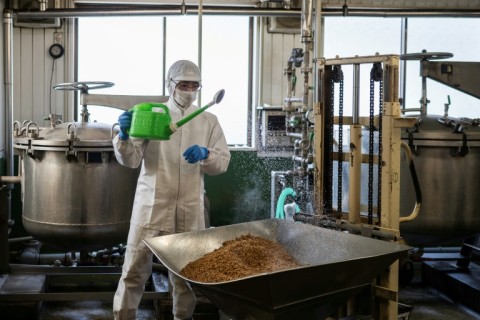 At his factory west of Tokyo, workers wash, steam and lavishly spray bacteria on soybeans that machines assemble in cups, before fermenting them for 18 hours