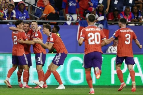 Scotland players celebrate after John McGinn (2L) scored their winning goal against Haiti