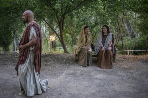 Actors dressed as Ancient Greeks wait backstage to perform in the opera 'Medea'