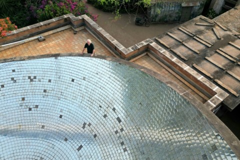 Engineer Gilles Guigan atop the solar bowl which helps fuels Auroville's communal kitchen