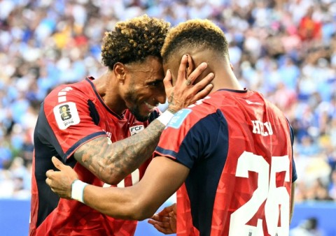 Cape Verde's forward Helio Varela (26) celebrates with teammate Ryan Mendes after scoring his team's equaliser in a 2-2 draw with Uruguay