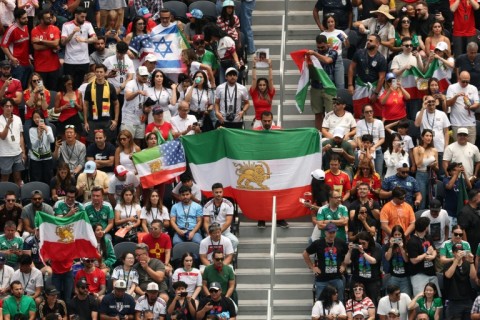 Iranian fans show pre-revolutionary Iranian flags during the 2026 World Cup Group G football match between Belgium and Iran in Los Angeles