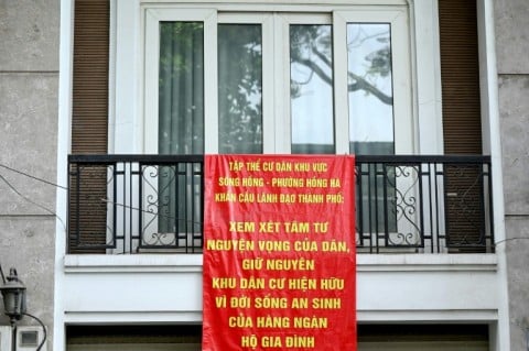 Residents hang banners from their balconies to urge authorities to ' consider people's aspiration in maintaining the present communities'