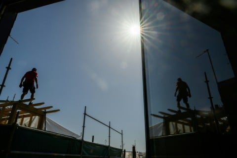 A carpenter on a rooftop in Nantes during France's hottest May on record