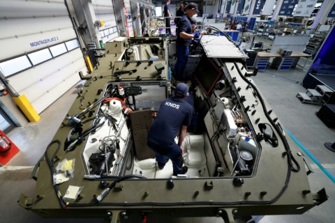 Employees work on a new production line of KNDS vehicles