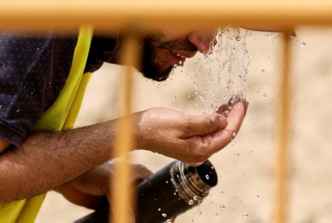 A worker cooled off at a road works in Madrid on June 22