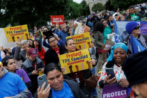 Demonstrators chanted and held signs outside the US Supreme Court as it weighed ending temporary protected status for Haitians and Syrians