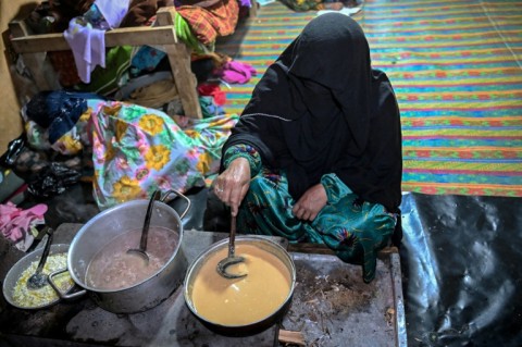 Habiba preparing breakfast before going to work at a wheat field in Eshtiwi village