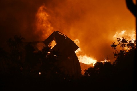 Flames from a wildfire fill the night sky and burns two factories in the Greek city of Thessaloniki