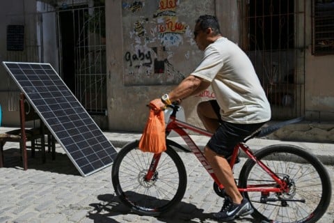 A man rides past a solar panel during a nationwide power outage in Havana -- the third such loss of power since January, when the United States imposed a fuel blockade on the island