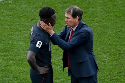 US forward Folarin Balogun is consoled by Belgium coach Rudi Garcia after the last-16 match in Seattle
