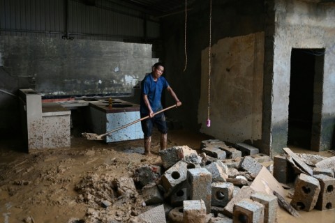 Residents of China's Liulan began the long process of cleaning up their wrecked homes after devastating storms